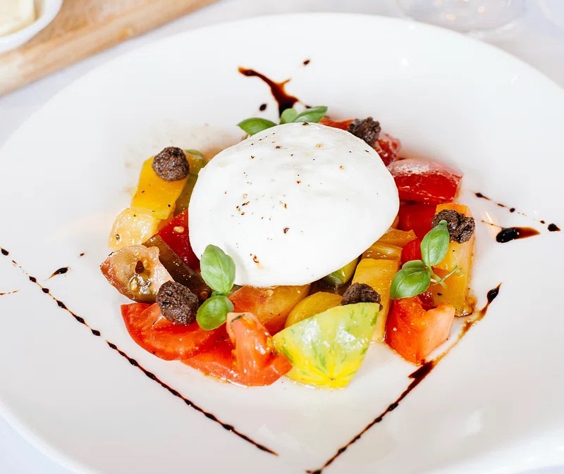 Assorted easy burrata dishes beautifully presented, including salads, pastas, and desserts with fresh ingredients