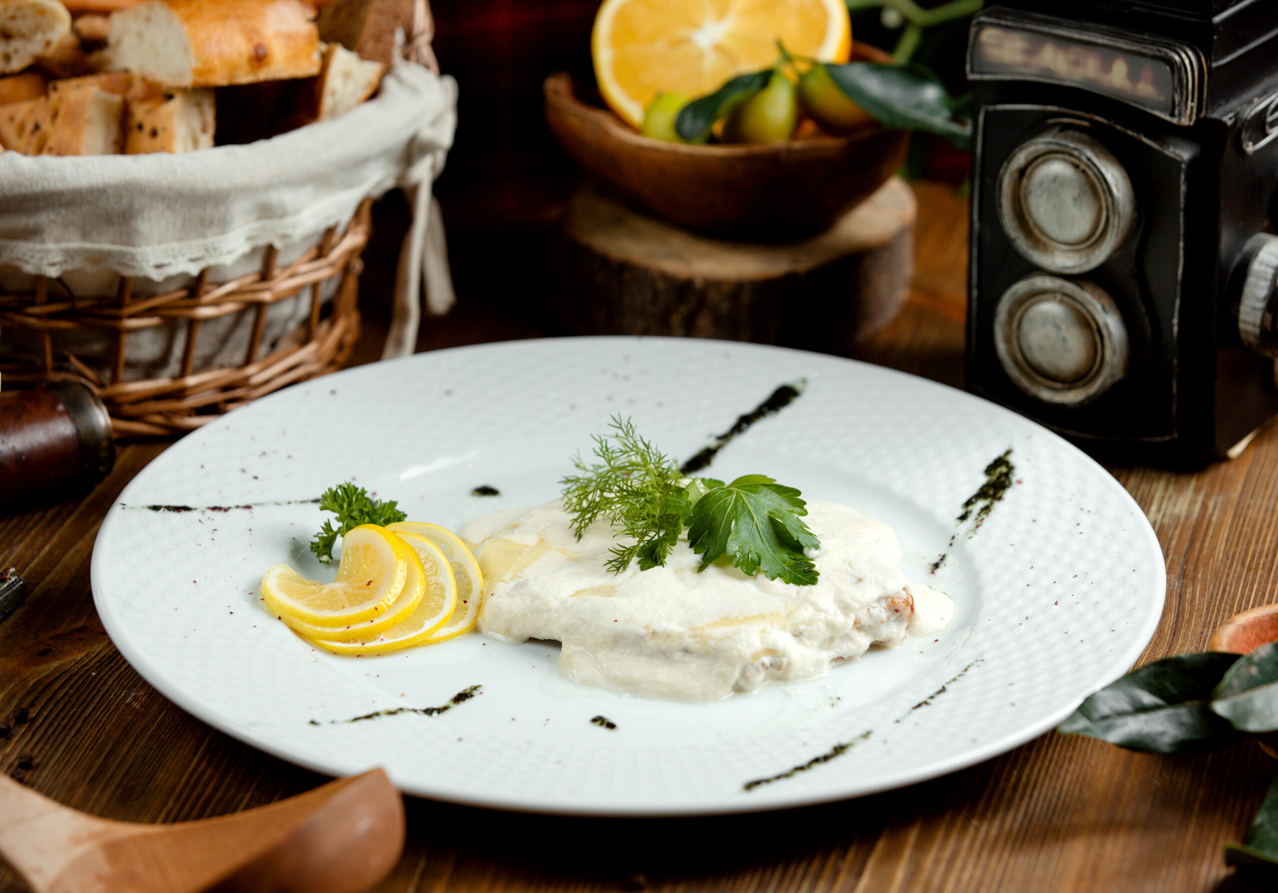 Assorted dishes featuring creamy burrata cheese, including salads, pizzas, and desserts, beautifully arranged on a dining table